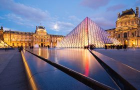Paris, France - May 13, 2014: View of the Louvre Museum and the Pyramid at twilight, it is one of the world's largest museums, a historic monument and a central landmark of Paris.